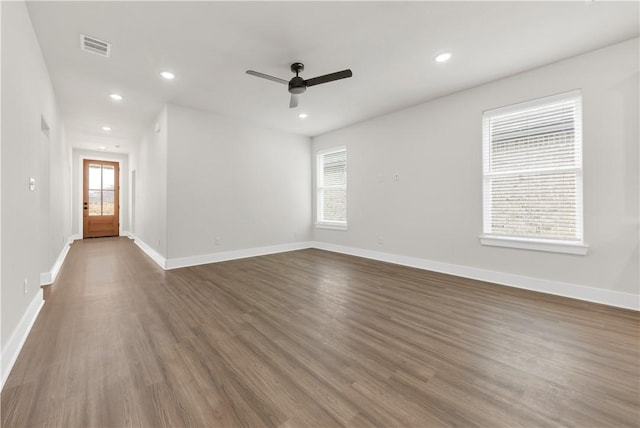 unfurnished room featuring ceiling fan and dark hardwood / wood-style flooring