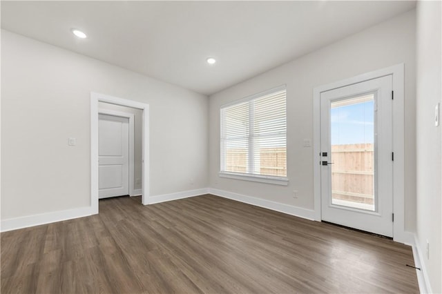 spare room with dark wood-type flooring