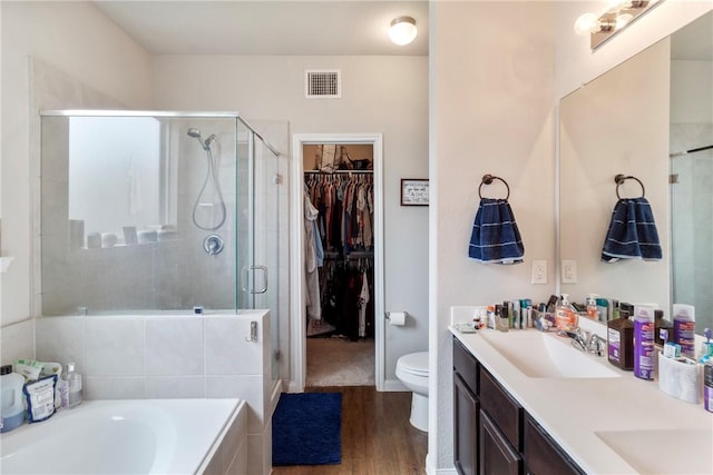 974 Marquis Dr, Bryan, TX 77803 - full bath with wood finished floors, a stall shower, double vanity, and a garden tub