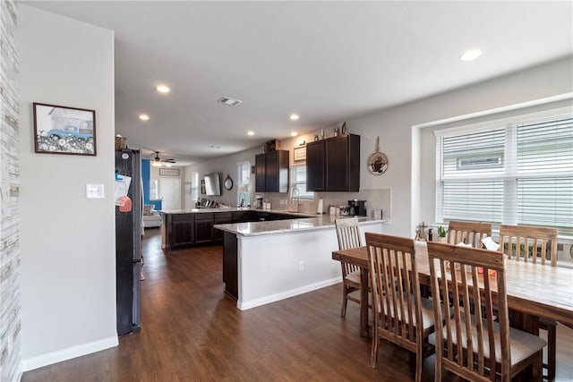 974 Marquis Dr, Bryan, TX 77803 - kitchen featuring a peninsula, dark wood finished floors, dark brown cabinets, recessed lighting, and ceiling fan