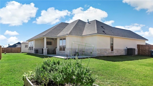 back of house featuring a lawn, ceiling fan, cooling unit, and a patio area