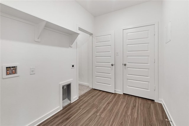 laundry area with hookup for a washing machine, hookup for an electric dryer, laundry area, dark wood-type flooring, and baseboards