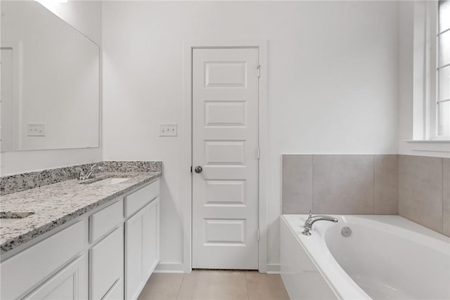 full bathroom featuring double vanity, a garden tub, a sink, and tile patterned floors