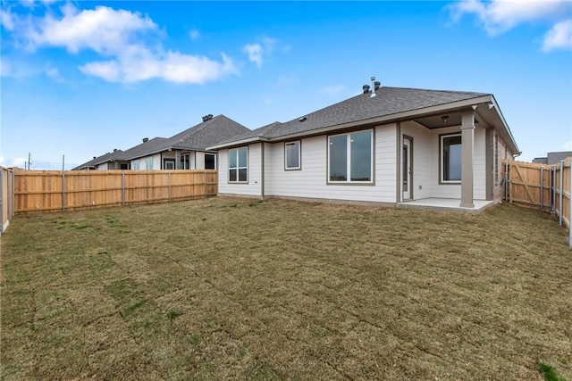 rear view of property with a patio area, a fenced backyard, and a yard