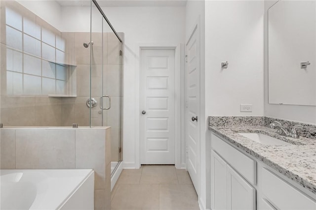 full bathroom with a washtub, a shower stall, vanity, and tile patterned floors