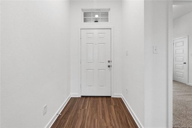 doorway to outside with dark wood-style flooring and baseboards