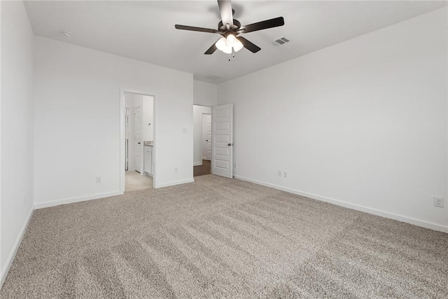 unfurnished bedroom with light carpet, baseboards, visible vents, connected bathroom, and ceiling fan