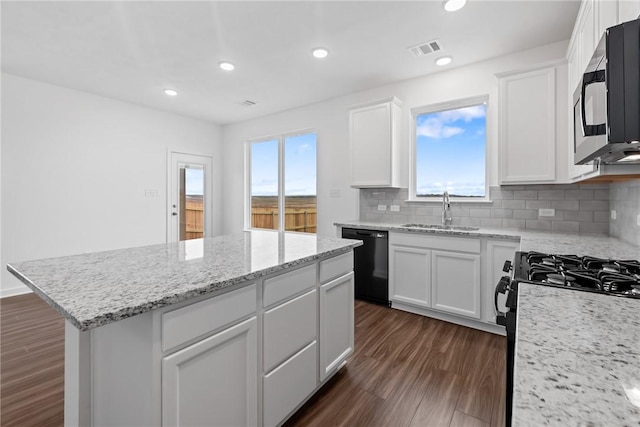 kitchen featuring black appliances, visible vents, white cabinets, and a sink