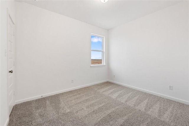 carpeted spare room with baseboards