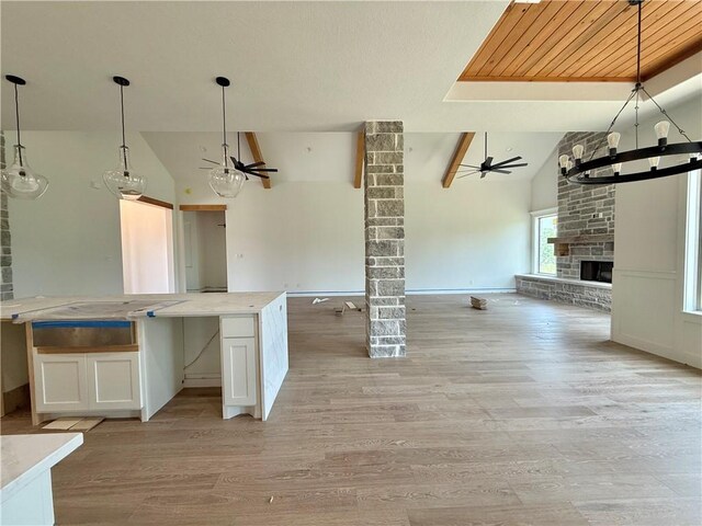 10070 Crown Pt, Iola, TX 77861 - kitchen with open floor plan, lofted ceiling, a ceiling fan, white cabinets, and a chandelier