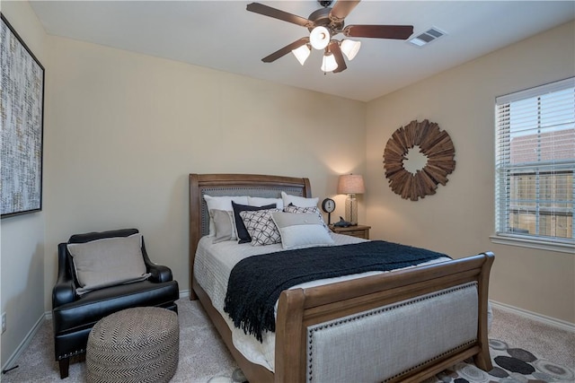 carpeted bedroom with a ceiling fan, baseboards, and visible vents