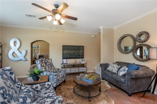 living room with visible vents, ornamental molding, baseboards, ceiling fan, and arched walkways