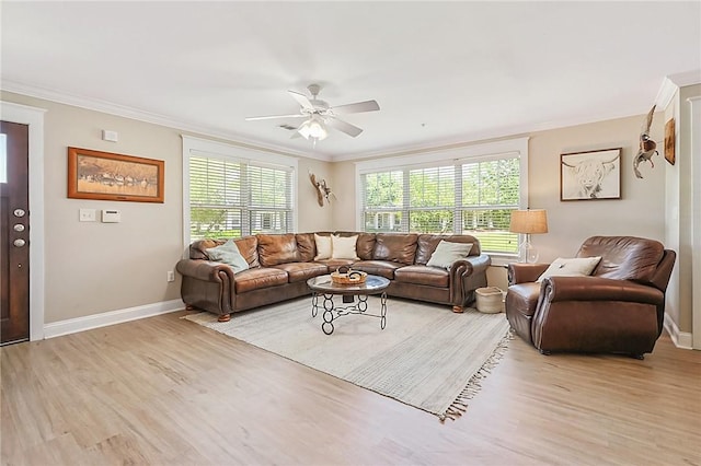living room featuring light wood-style flooring, crown molding, and a healthy amount of sunlight