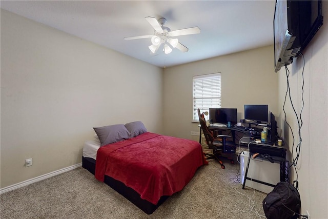 carpeted bedroom with ceiling fan and baseboards