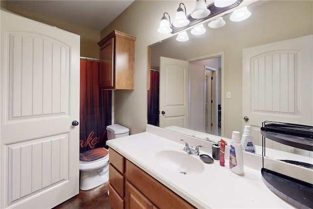 bathroom with toilet, a chandelier, and vanity