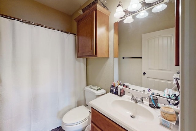 bathroom featuring vanity, a shower with shower curtain, and toilet