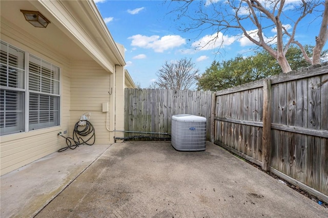 view of patio / terrace with a fenced backyard and central air condition unit