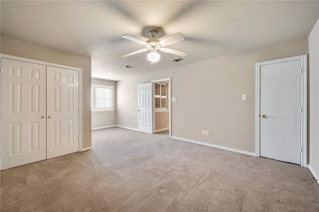 unfurnished bedroom featuring baseboards, carpet, visible vents, and a closet