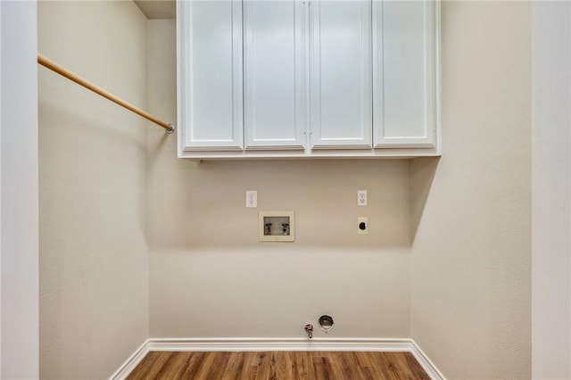 laundry area with baseboards, hookup for a gas dryer, wood finished floors, washer hookup, and electric dryer hookup