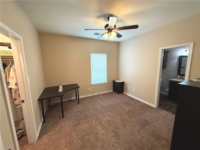 4008 Oaklawn St, Bryan, TX 77801 - unfurnished bedroom with carpet, baseboards, ensuite bath, and a ceiling fan