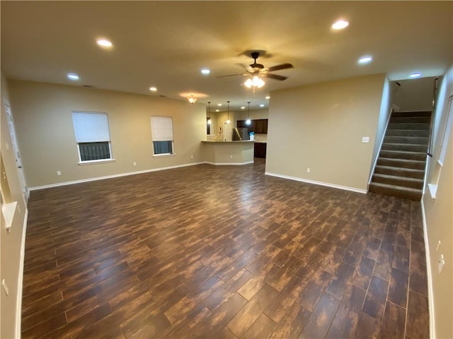 4008 Oaklawn St, Bryan, TX 77801 - unfurnished living room featuring dark wood-type flooring, recessed lighting, a ceiling fan, and baseboards