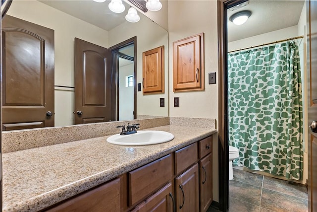 2409 Stone Castle Cir, College Station, TX 77845 - full bathroom featuring toilet, vanity, a shower with curtain, and stone finish floors