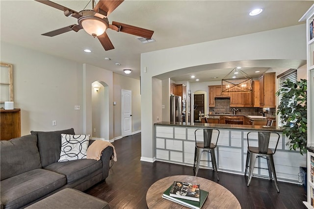2409 Stone Castle Cir, College Station, TX 77845 - living area with arched walkways, ceiling fan, dark wood-style floors, and recessed lighting