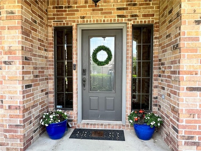 2409 Stone Castle Cir, College Station, TX 77845 - doorway to property with brick siding