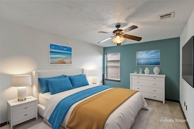 2409 Stone Castle Cir, College Station, TX 77845 - bedroom featuring light carpet, a ceiling fan, and baseboards
