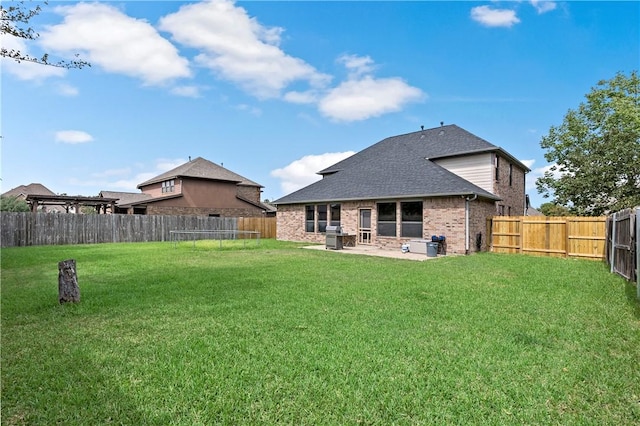 2409 Stone Castle Cir, College Station, TX 77845 - rear view of house with a patio area, brick siding, and a shingled roof