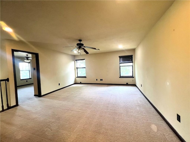 2409 Stone Castle Cir, College Station, TX 77845 - empty room featuring a ceiling fan, healthy amount of natural light, and light carpet