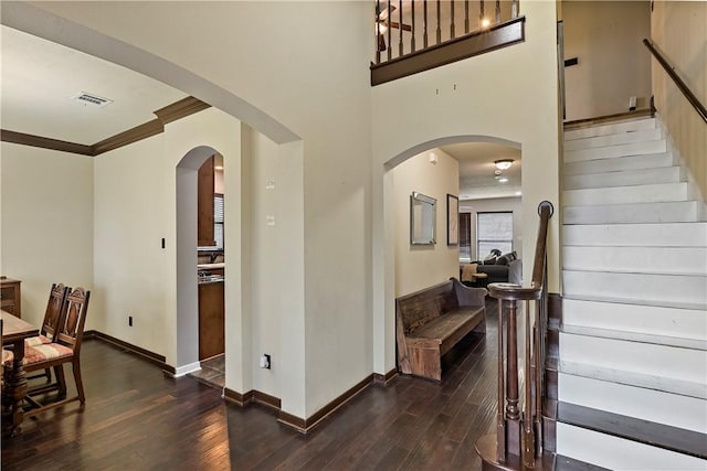 2409 Stone Castle Cir, College Station, TX 77845 - foyer entrance with wood-type flooring, stairs, baseboards, and ornamental molding