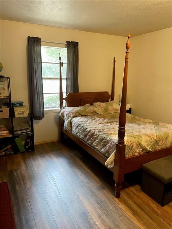 bedroom featuring dark hardwood / wood-style floors and a textured ceiling