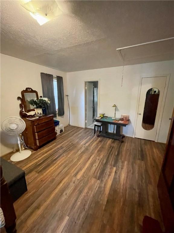 misc room with hardwood / wood-style flooring and a textured ceiling