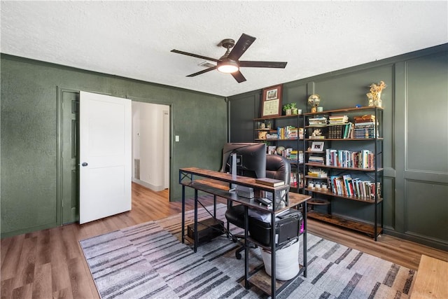 office area featuring visible vents, a textured ceiling, ceiling fan, and wood finished floors