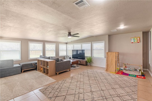 interior space with visible vents, lofted ceiling, and ceiling fan