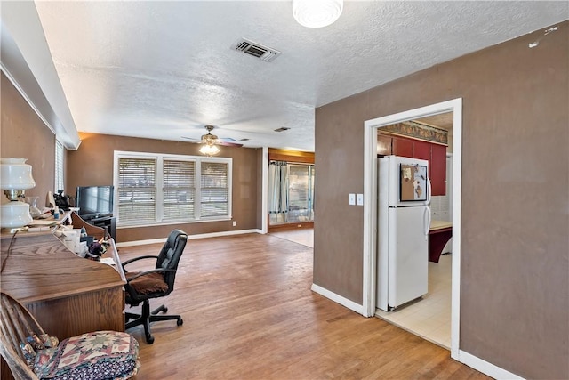 office space with ceiling fan, wood-type flooring, and a textured ceiling