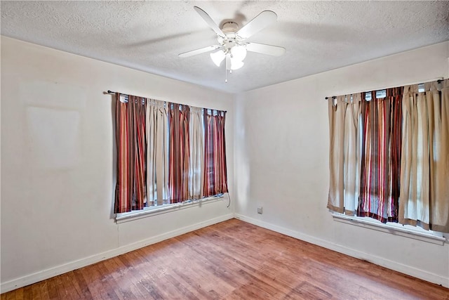 spare room with wood-type flooring, a textured ceiling, and ceiling fan