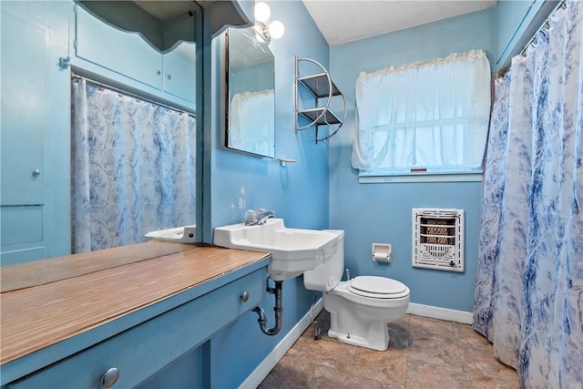 bathroom with toilet and heating unit