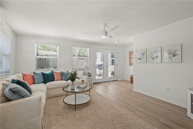 1203 Hawk Tree Dr, College Station, TX 77845 - living room featuring light wood finished floors, ceiling fan, baseboards, and french doors