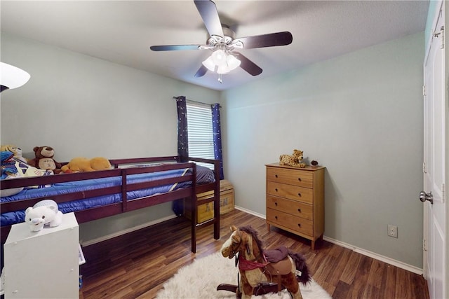 bedroom with ceiling fan and dark wood-type flooring