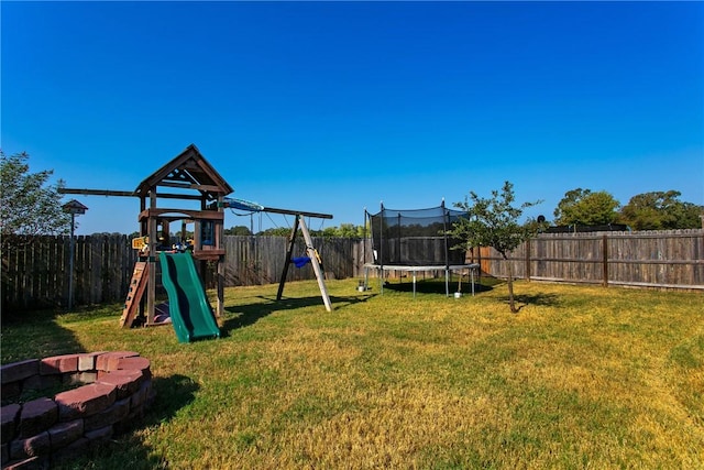 view of yard featuring a playground and a trampoline