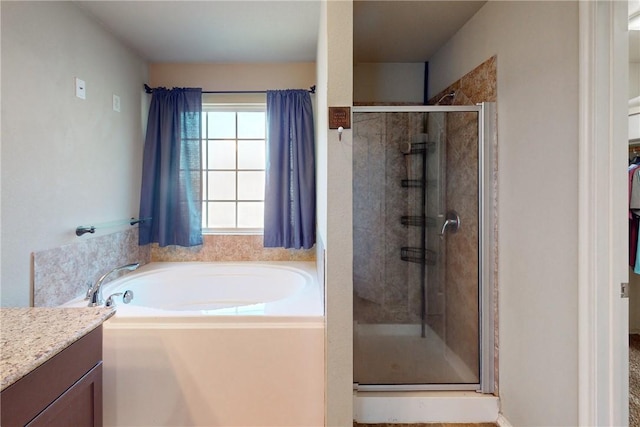 bathroom featuring vanity and shower with separate bathtub