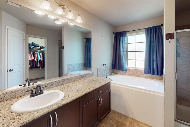 bathroom featuring vanity and shower with separate bathtub