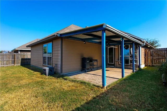 back of property featuring a lawn and a patio area