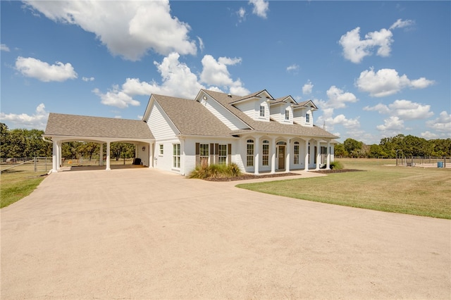 view of front of property featuring a front yard and a carport