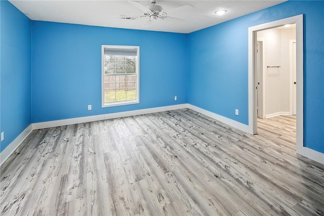 unfurnished room featuring ceiling fan and light wood-type flooring