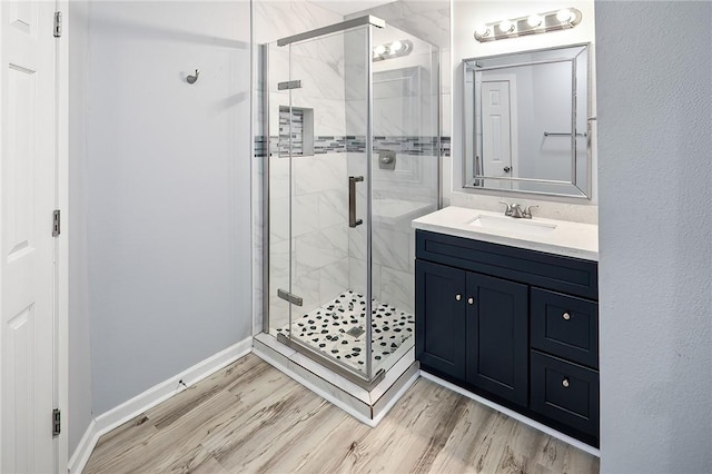 bathroom featuring vanity, an enclosed shower, and hardwood / wood-style floors