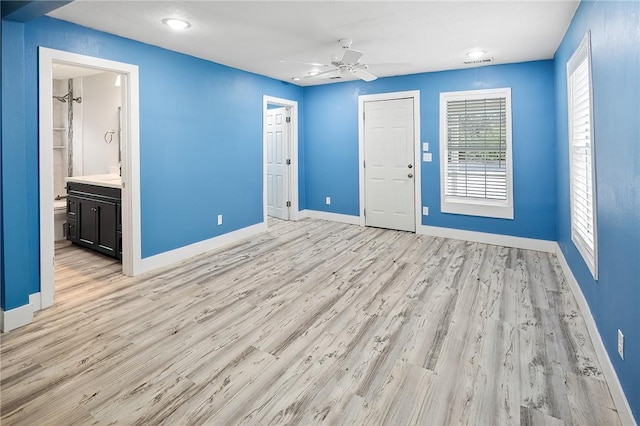 empty room with ceiling fan, sink, and light wood-type flooring