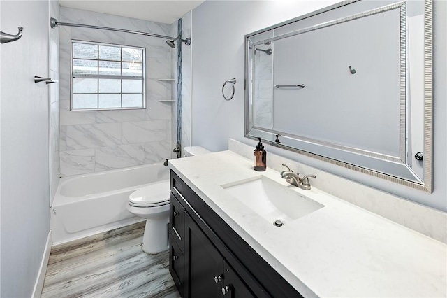 full bathroom with vanity, toilet, tiled shower / bath combo, and hardwood / wood-style floors